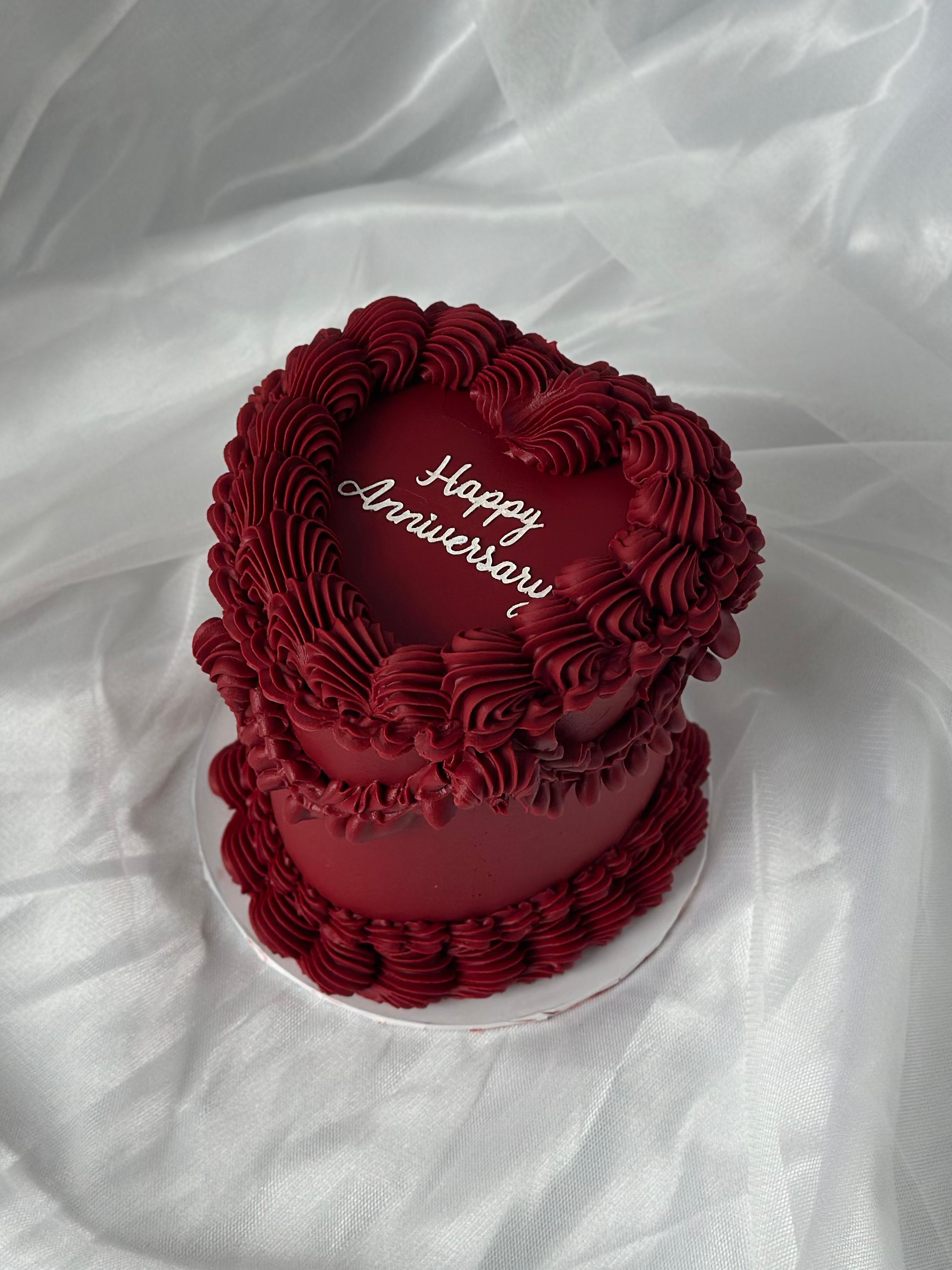 Anniversary cake with blush buttercream ruffles and pearls