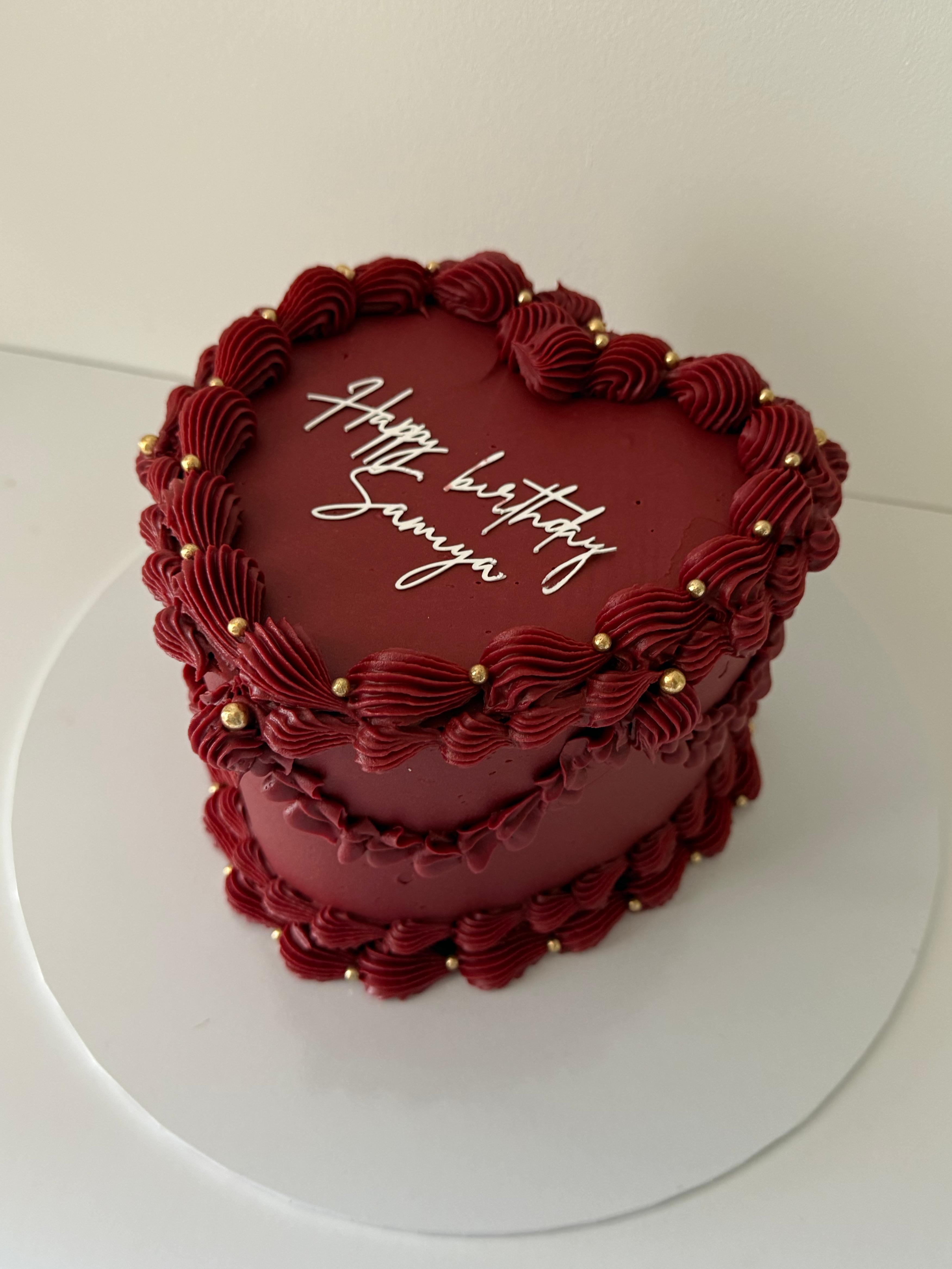 Two-tier vintage-inspired birthday cake with piped shells